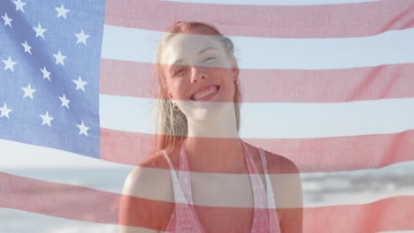 Animation-of-flag-of-usa-over-happy-caucasian-woman-on-beach-in-summer