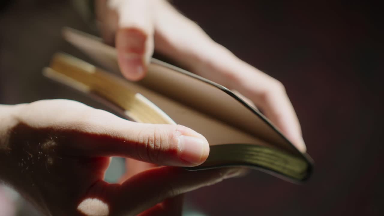 Hands holding open book, highlighting reflection and contemplation