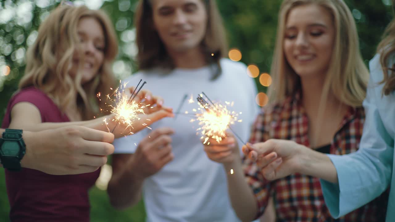 Happy Friends With Sparklers Having Fun Outdoors