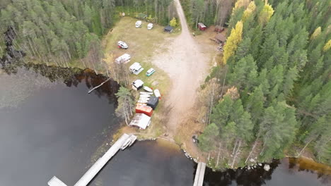 Camping-Ground-By-The-Lakeshore-With-Spruce-Trees-During-Autumn-In-Sweden