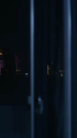 warsaw cityscape at night through a window