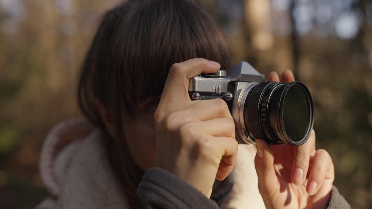Woman taking photo with vintage camera
