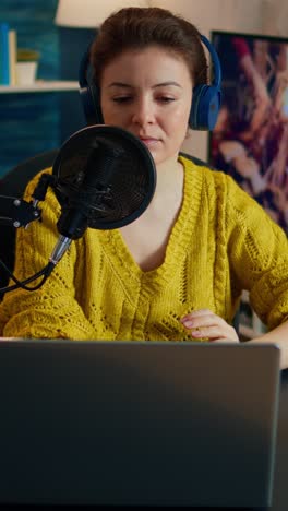 vertical video: creative influencer with headphones preparing to speak with fans