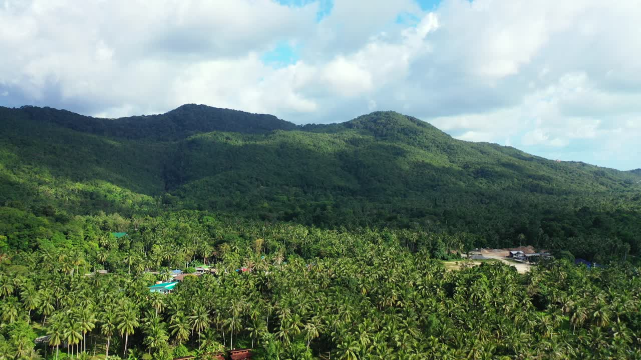 Lush Jungle Mountains in the shade from the big clouds. Aerial landscape. Preserved nature and rainforest,