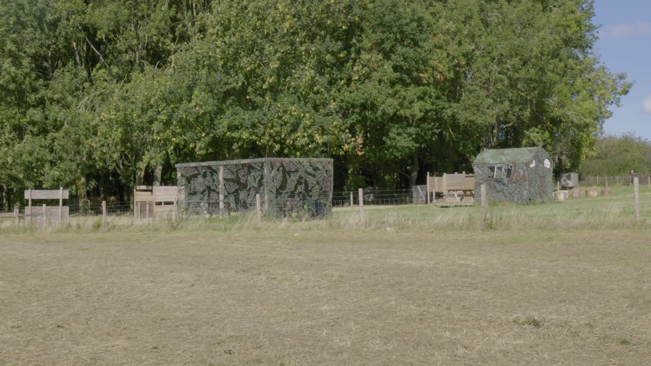 Paintball field recreational area various structures camouflage netting used as cover during games