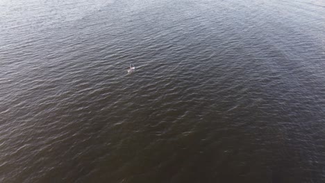 Isolated-person-paddle-sup-on-waters-sea-of-Punta-del-Este-in-Uruguay