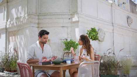 smiling lovers talking together in city restaurant. fancy couple enjoying dating