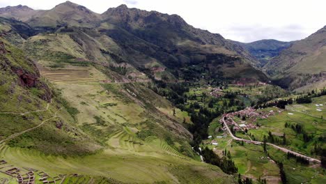 full view of the ruins in pisac archeological park in the sacred valley of the incas showing the town and terraces in it - reverse drone shot