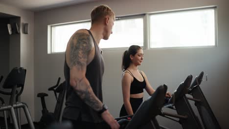 man and woman working out at the gym