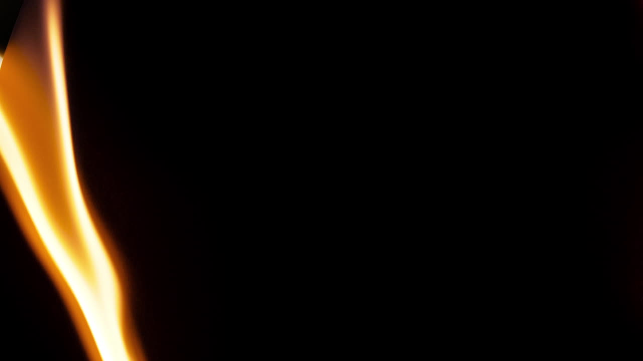 Close Up of a Flickering Candle Flame in Darkness