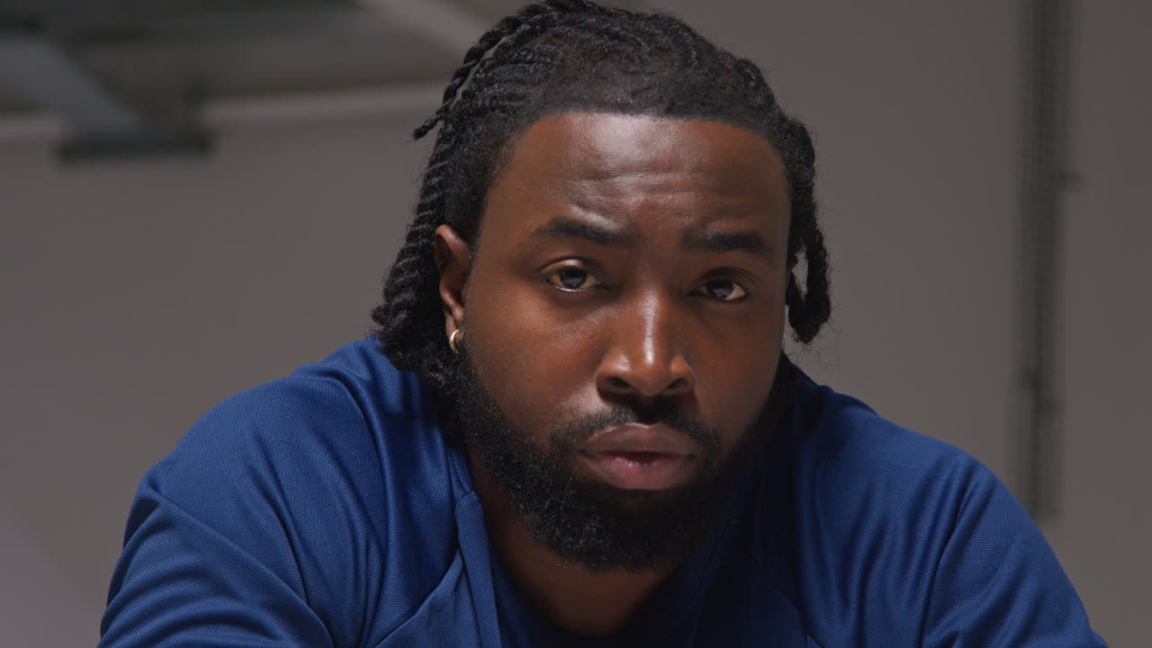 Close Up Portrait Of Determined Male Athlete Sport Training In Gym Sitting And Concentrating In Changing Room With Focused Expression 1