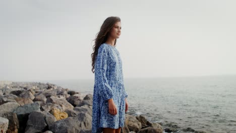 woman in blue dress at the coastline