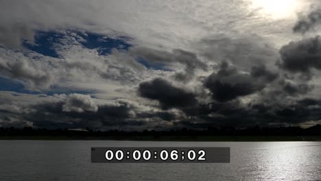 time lapse of a dramatic sky at dusk, with normal speed for the lake