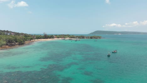 Crystal-clear-tropical-water-on-the-shallow-M'pai-Bay-in-Koh-Rong-Sanloem-Island,-Cambodia---Aerial-Fly-over-shot