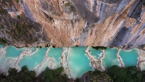 amazing aerial shot with a drone from the andes area in ayacucho peru, of the famous turquoise millpu lake located between mountains in the afternoon