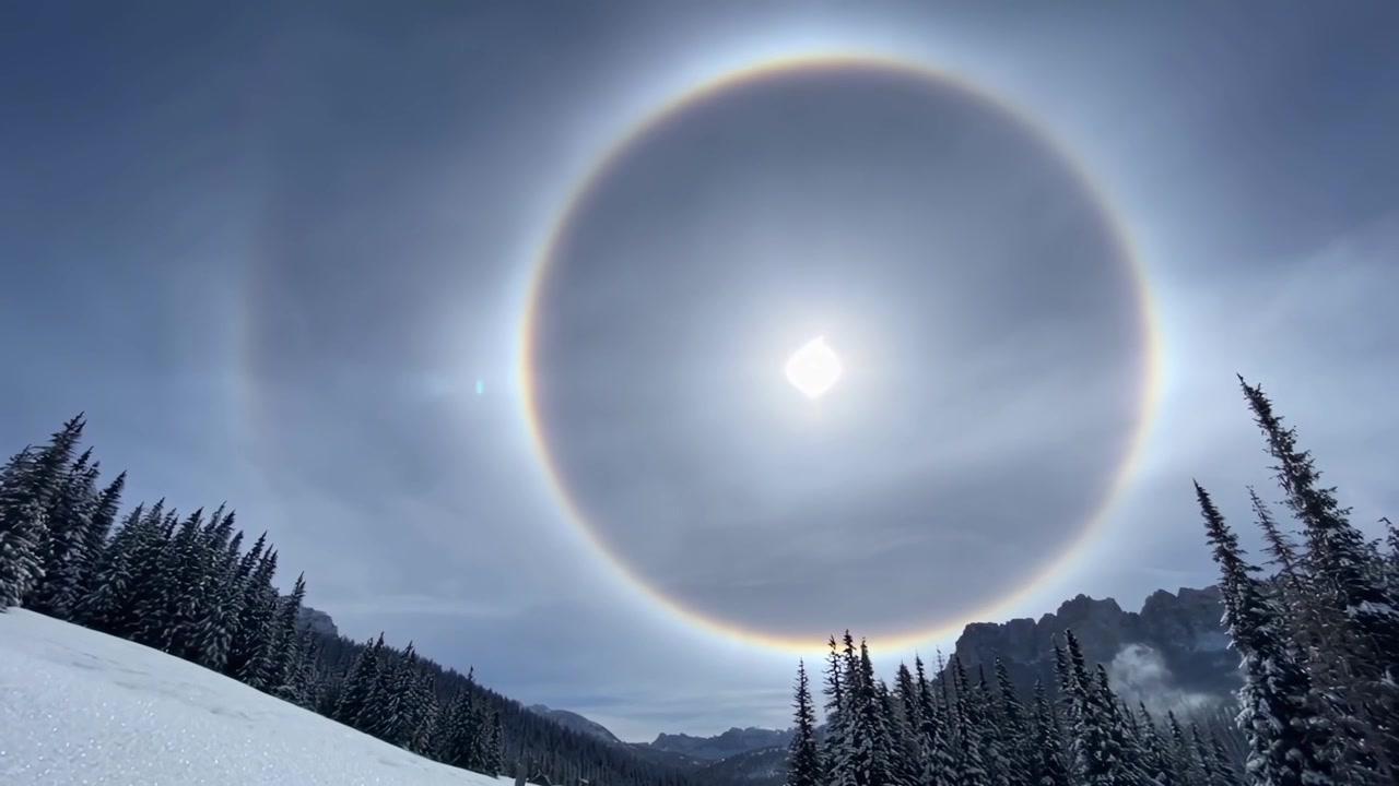 Sun Halo Over Snowy Mountain Landscape