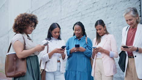 group of women outside office with phone