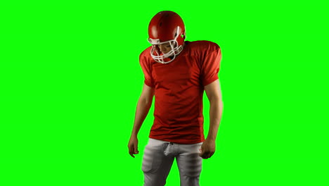 red serious american football player posing