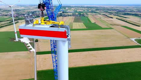 Wind-Turbine-Tower-Construction-At-Daytime---drone-shot