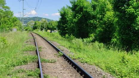 train tracks in rural germany connecting the cities of loerrach germany and basel in switzerland. slow zoom in shot.