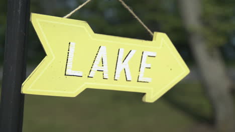 tilt up to reveal small yellow sign pointing to the lake