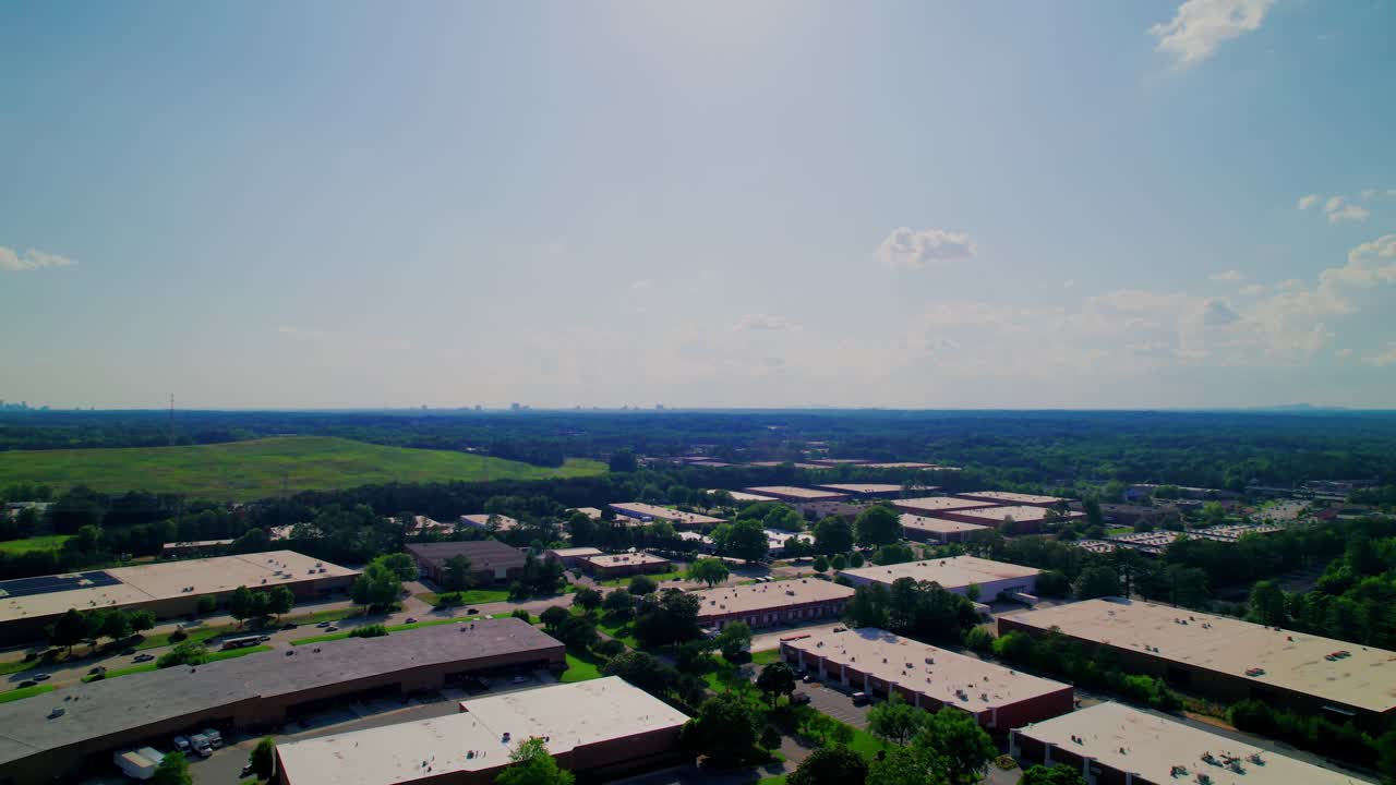 Wide drone flyover of Atlanta’s suburban business parks interwoven with lush woodlands—perfect for real estate, corporate, and environmental B-roll.