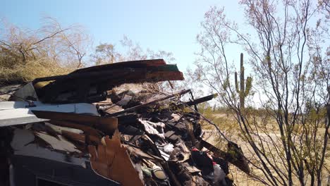 pan across abandoned trash trailer saugro cactus in the background, scottsdale, arizona