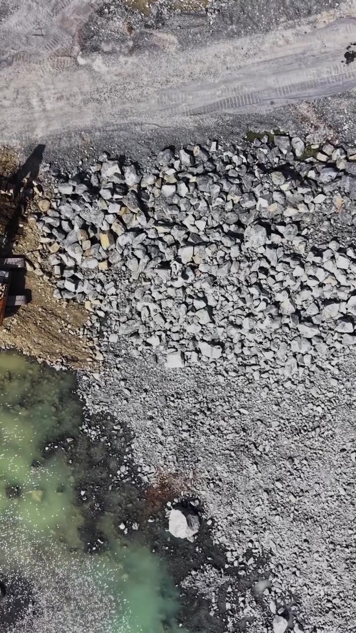 Stockpiles of white granite material at mining site