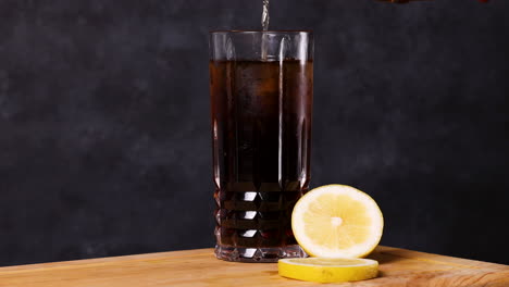 piscola cocktail, typical chilean drink wooden table dark background chile pisco, ice and coke