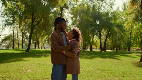 Father-hugging-daughter-in-sunny-autumn-park.-Emotional-connection-child-dad.