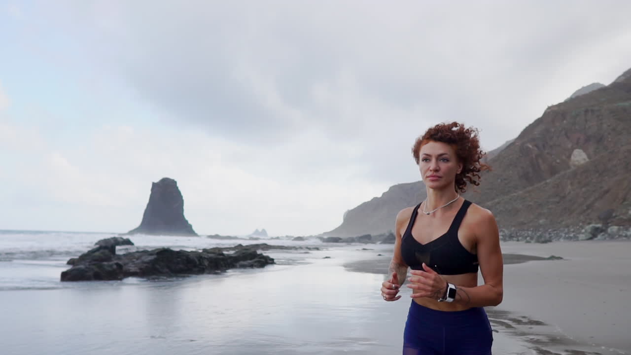Chasing Clouds by the Sea: Athletic Woman's Graceful Beach Run in Slow Motion