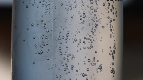 Close-up-view-of-mineral-bubbles-slowly-rising-up-to-the-water-surface