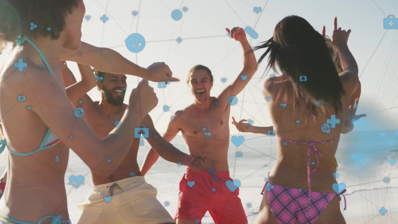 Man in red trunks cheering, initiating group dancing on beach for marketing, blue icons overlaying