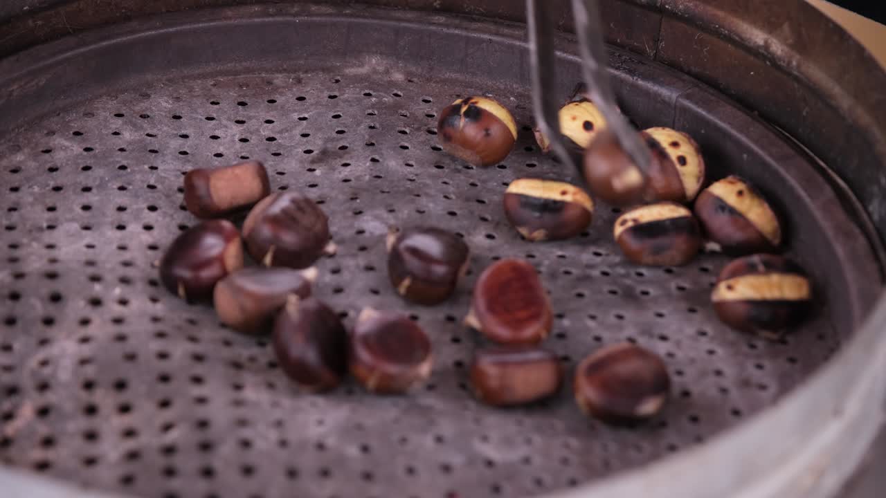 A street vendor in Turkey cooks chestnuts. This is a Turkish street flavor tradition.