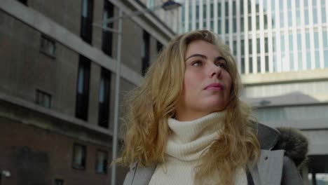 low angle close up of a stylish blonde woman walking confidently in the city