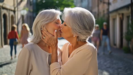 two senior women sharing a kiss in a street scene