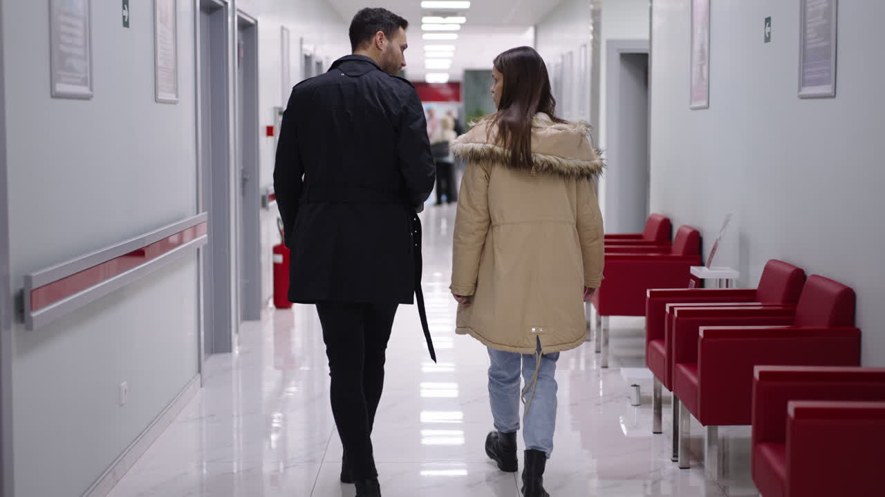 People Walking in Hospital Hallway