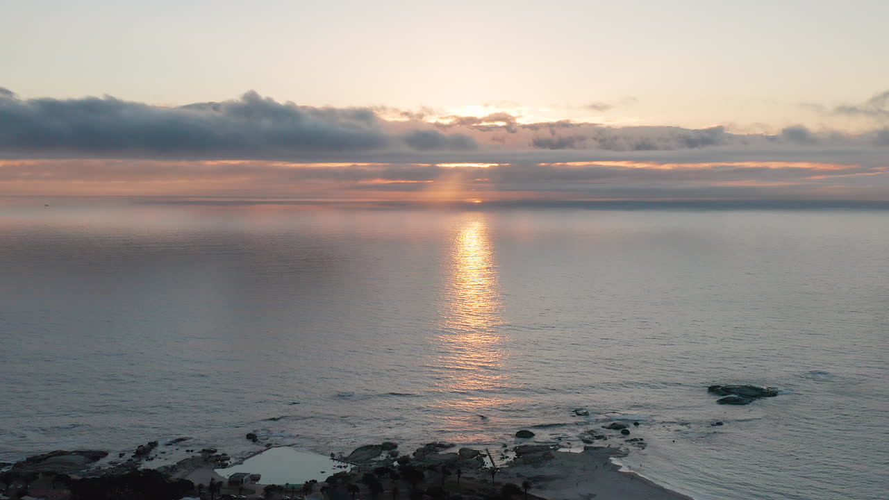 Aerial of sun behind the clouds and Clifton Beach in Cape Town in South Africa
