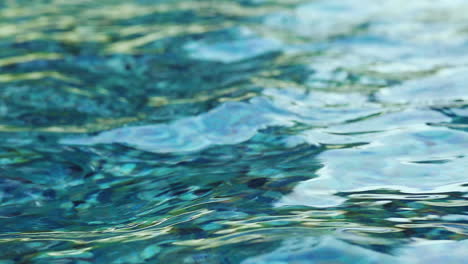 blue aqua water flows and ripples around the wishing well