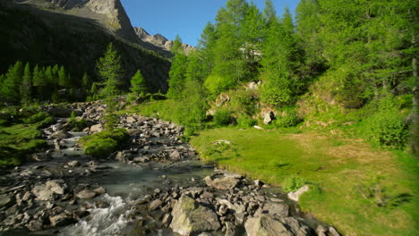 unspoiled nature of predarossa mountain travel destination in summer season with river flowing in val masino, italy