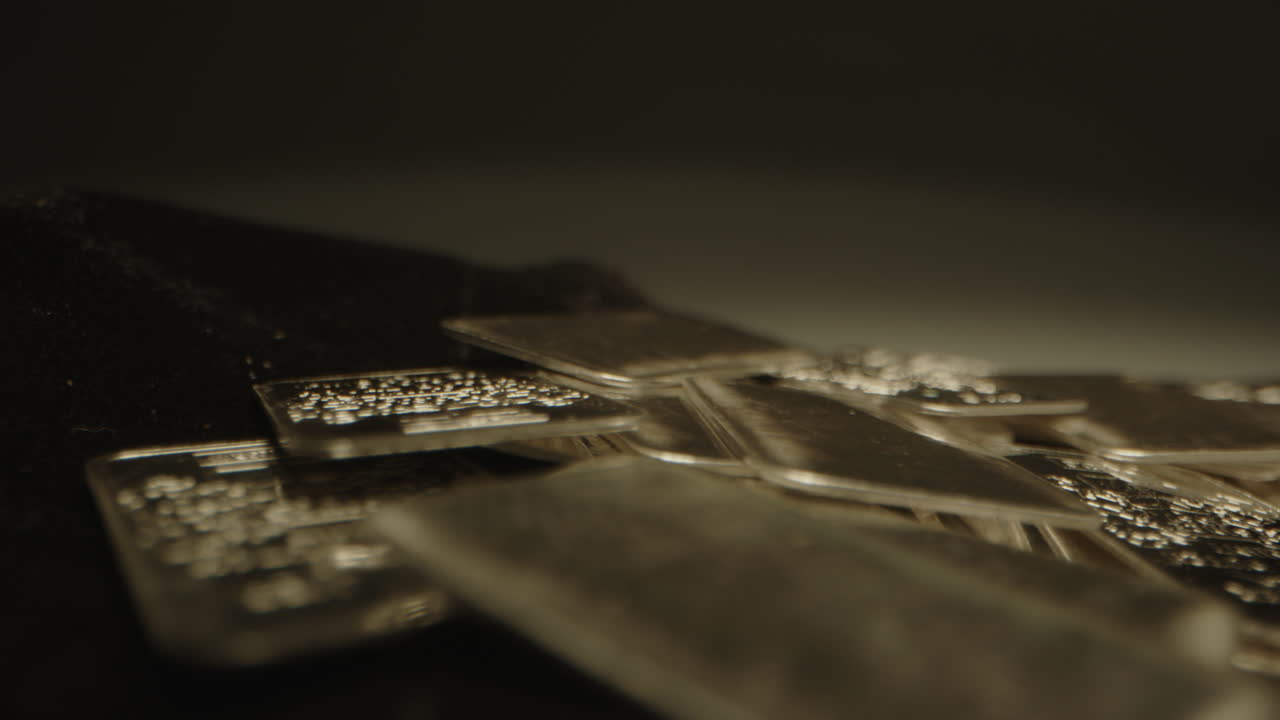 Detailed macro dolly of shiny silver bars. The precious metal plates are used as an investment
