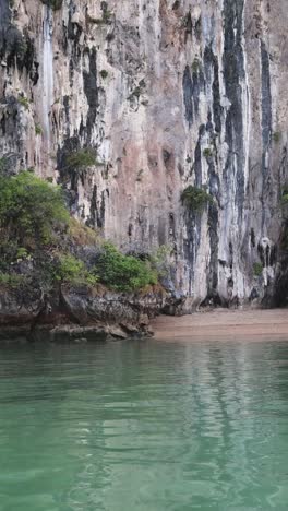 calm water gently laps against a rugged cliff