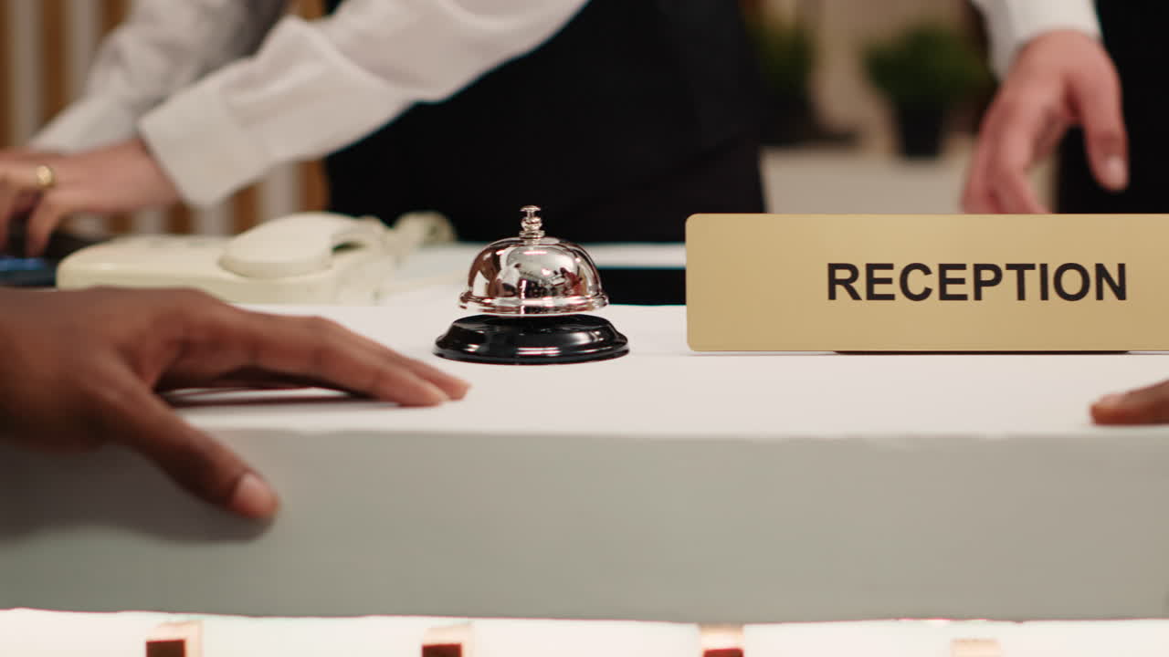 Guests ringing service bell at reception