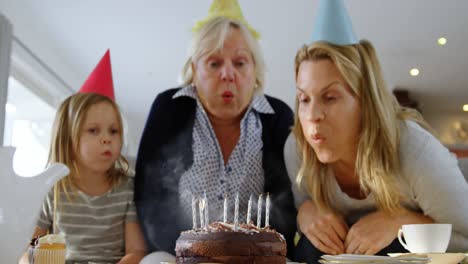 multi-generation family celebrating birthday on sofa 4k