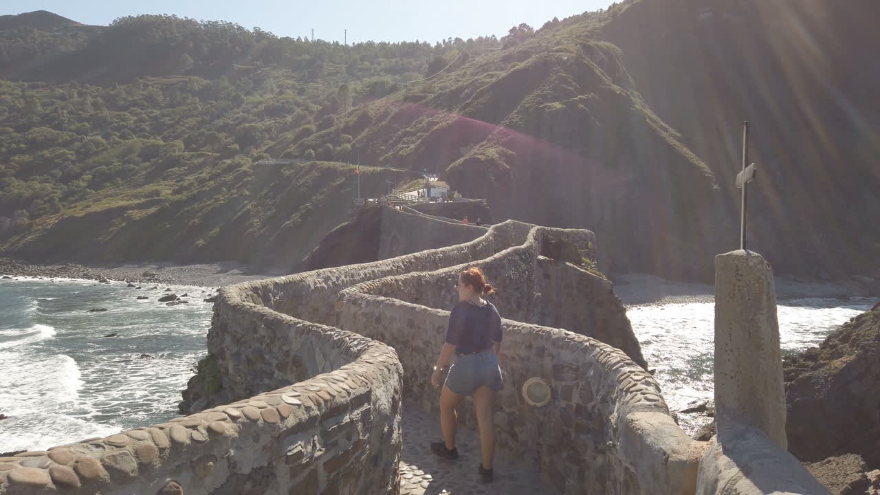 San Juan de Gaztelugatxe coast bridge with person