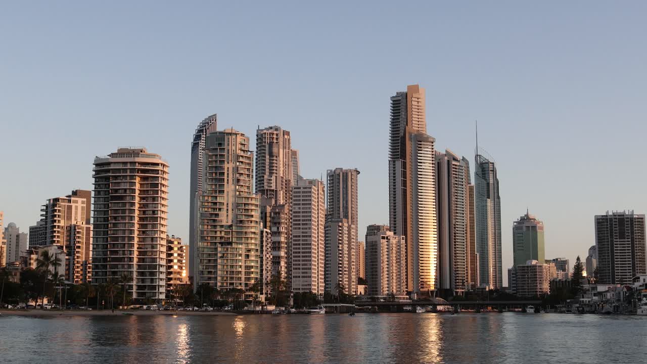 Cityscape changes as the sun sets over buildings