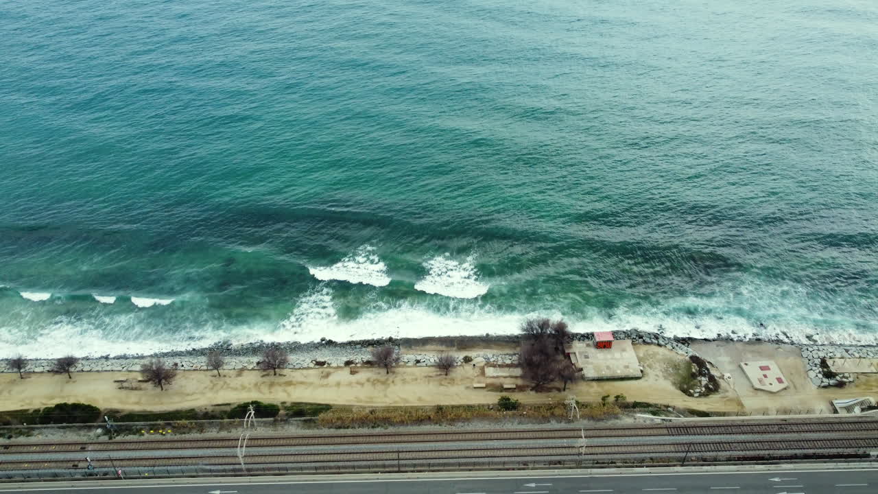 Coastal View with Ocean Waves and City Infrastructure