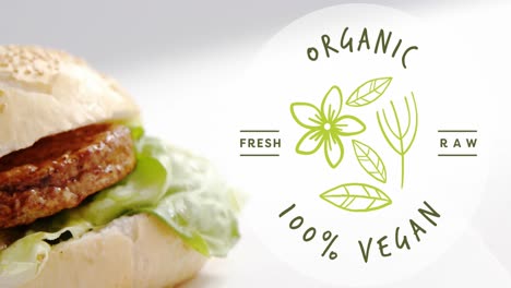 Animation-of-organic,-fresh,-raw,-100-percent,-vegan-text,-flower-and-leaves-over-vegetable-burger