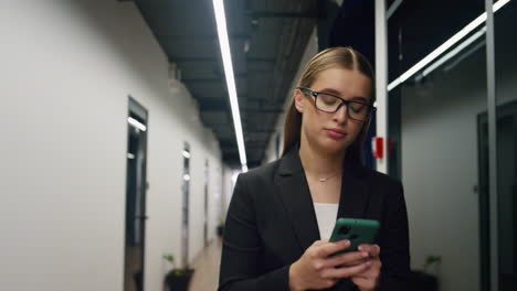 upset businesswoman check smartphone in office. disappointed girl get bad news