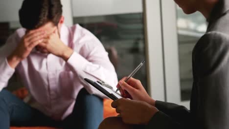 Depressed-man-talking-to-counselor